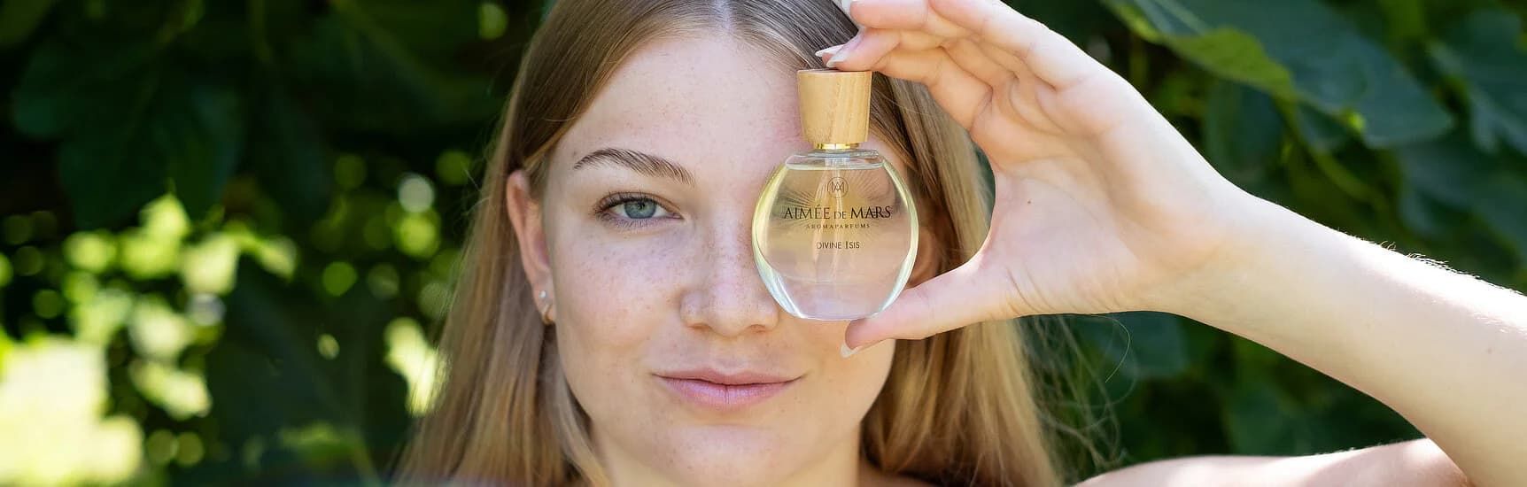Woman holding Aimée de Mars perfume